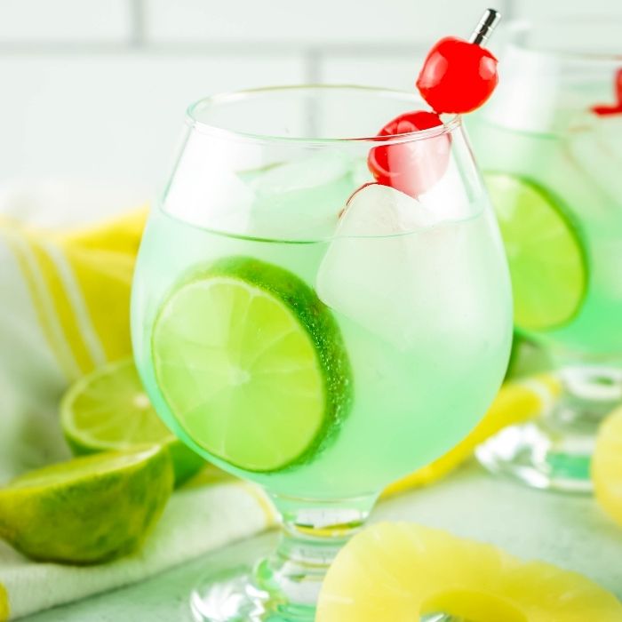 mermaid drinks on table with pineapple and limes 