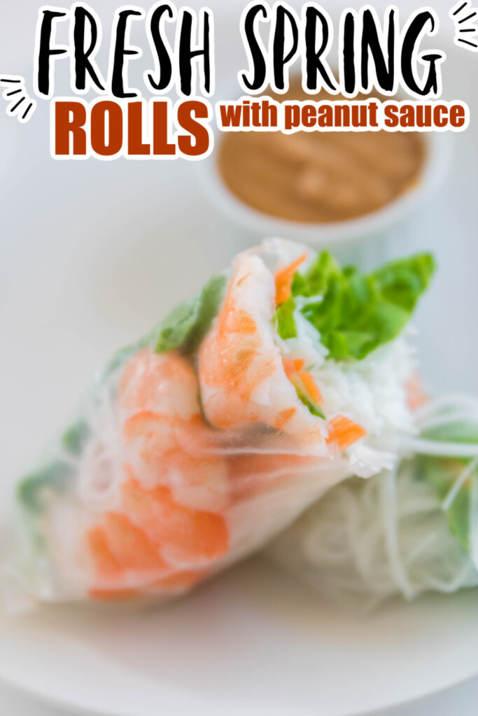 shrimp spring roll with shrimp on a white plate cut in half 