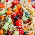close up of spaghetti salad in a glass bowl