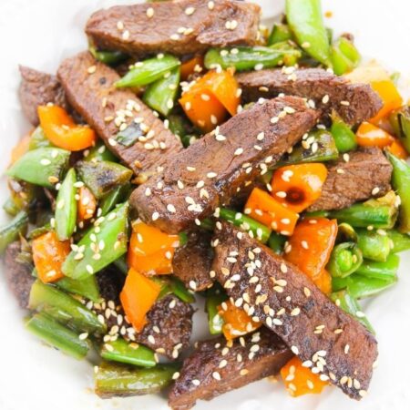 stir fry on a plate topped with sesame seeds