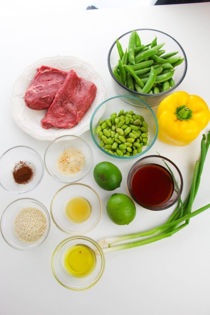 stir fry ingredients in bowls on white table 