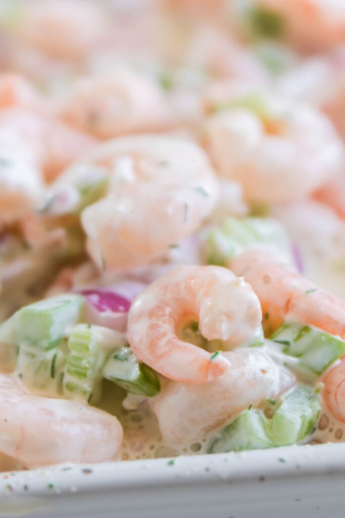 creamy shrimp salad in a container on table 