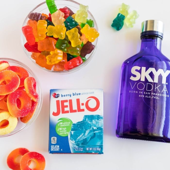 jello, vodka, gummy bears and peach rings on white counter