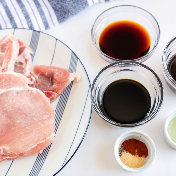 ingredients for pork chops on white counter 