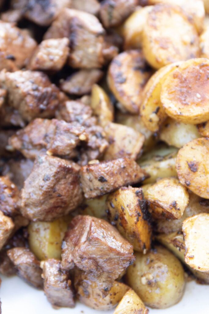 steak tips with potatoes on plate 