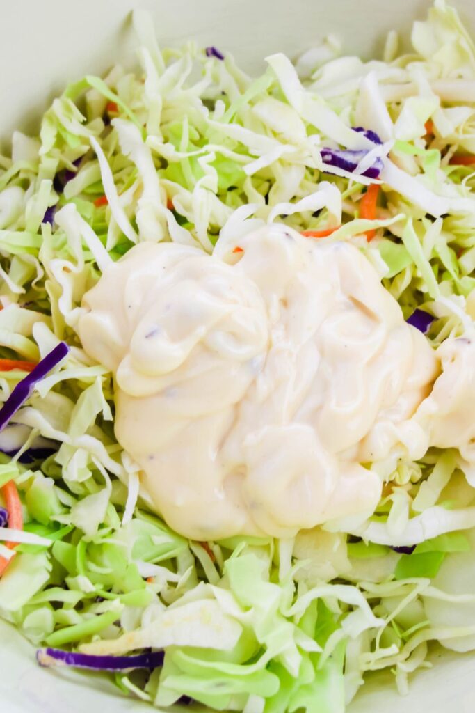 dressing poured on coleslaw mix