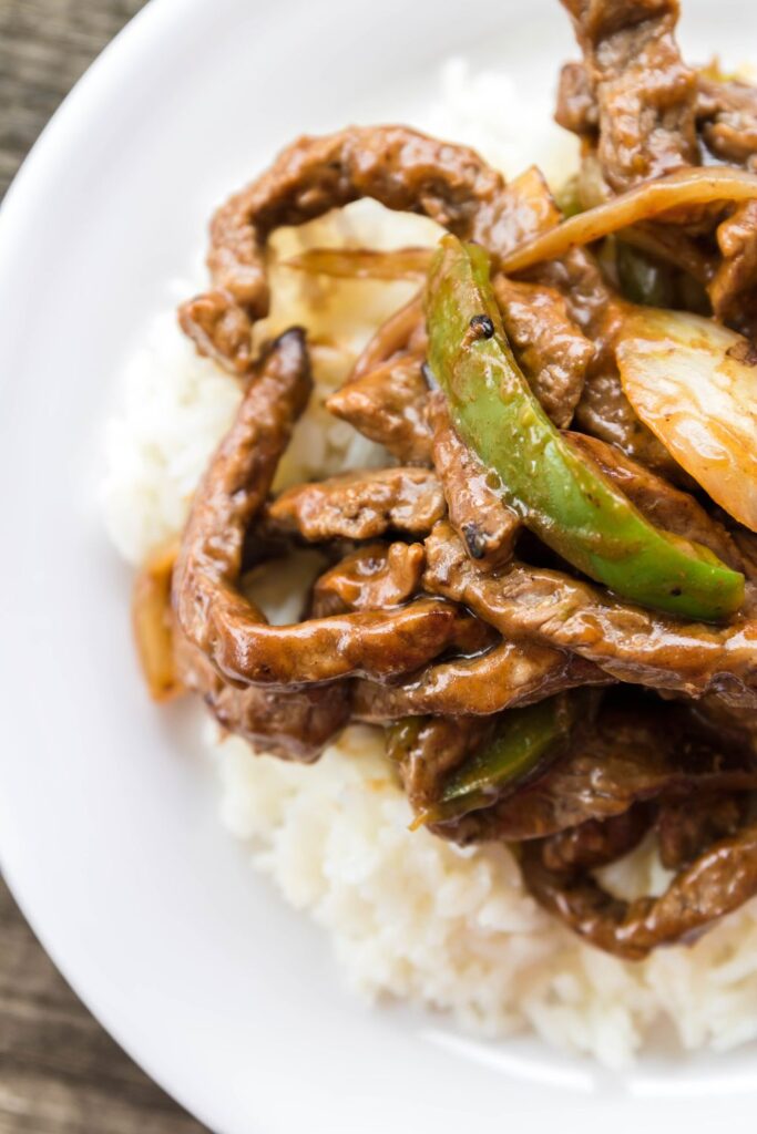 overhead shot of steak with peppers and onions