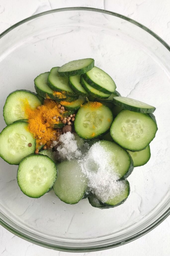 cucumbers in bowl with seasoning and such