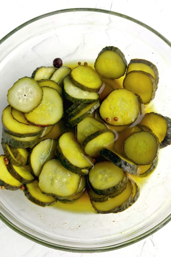 refrigerated pickles  in a glass pyrex bowl 