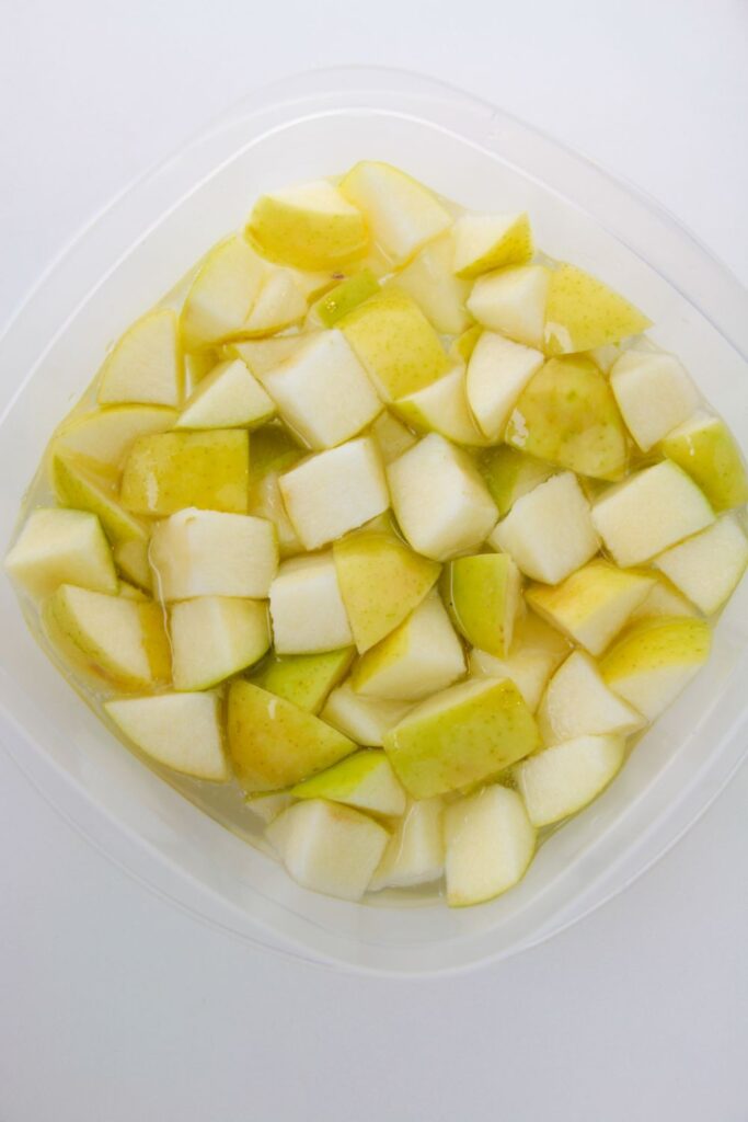 apples in lemon lime soda in a plastic container 