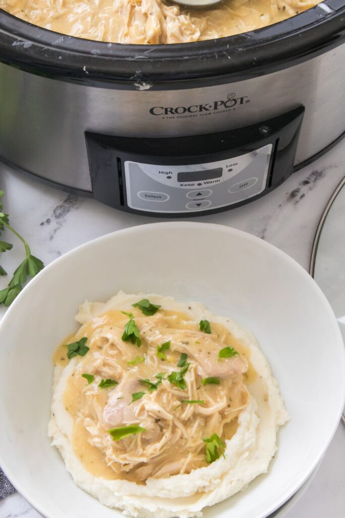 crock pot chicken and gravy served over mashed potatoes 