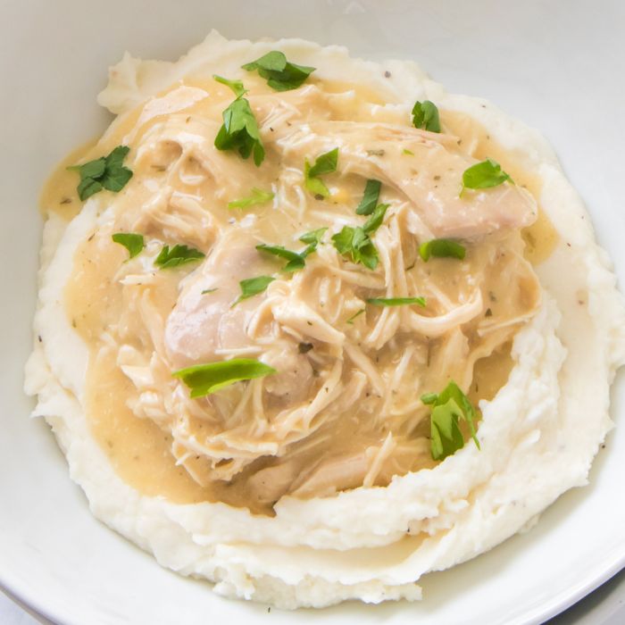 bowl of chicken and gray over mashed potatoes in a bowl 