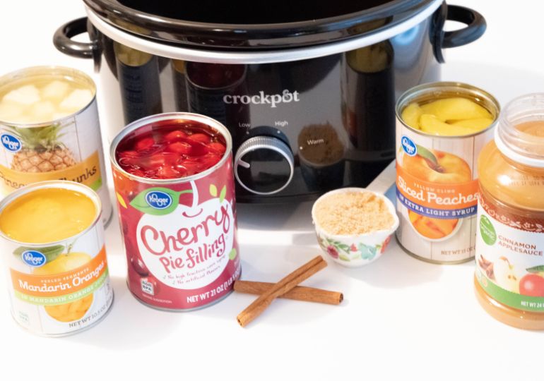 ingredients for fruit salad by crockpot on table 