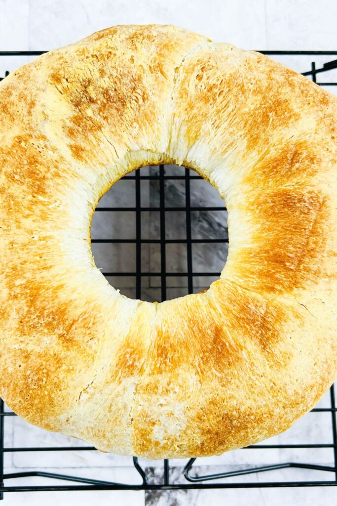 circle shaped french bread on cooling rack