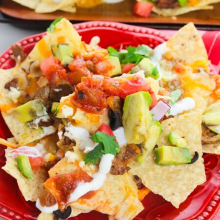 red plate with nachos piled on top