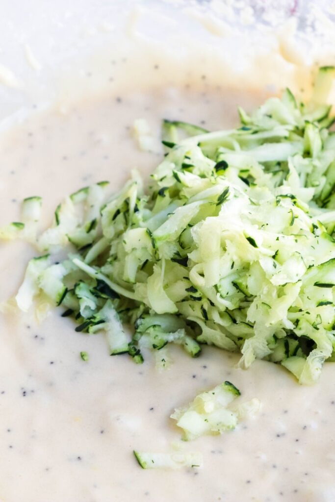 zucchini on top of muffin batter 