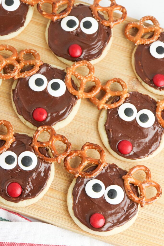 christmas reindeer cookies on wooden cutting board 