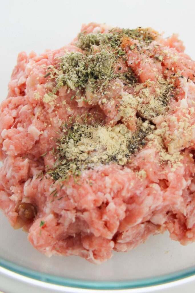 pork with seasonings on top in a bowl