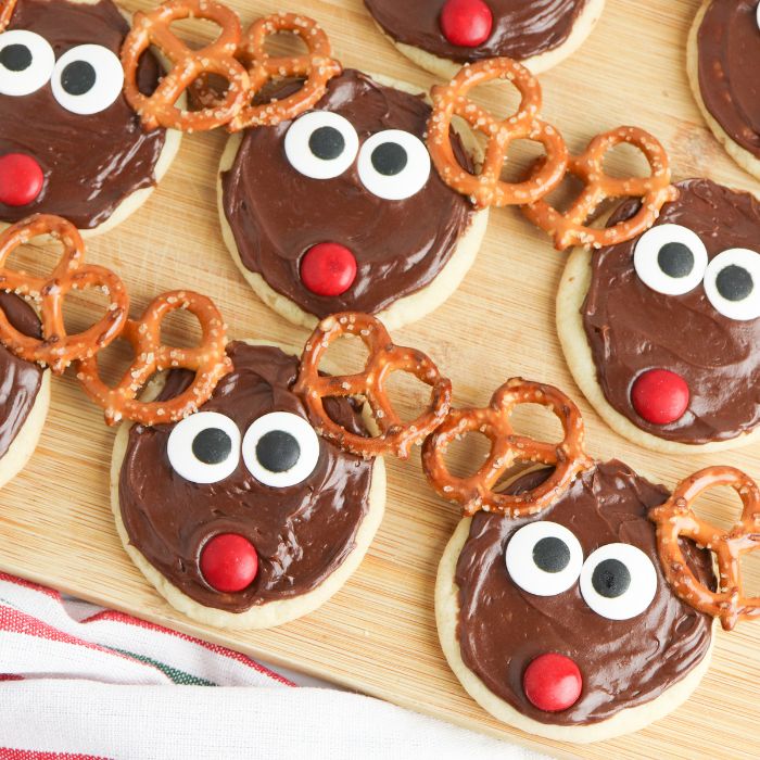 reindeer cookies on a wooden cutting board 