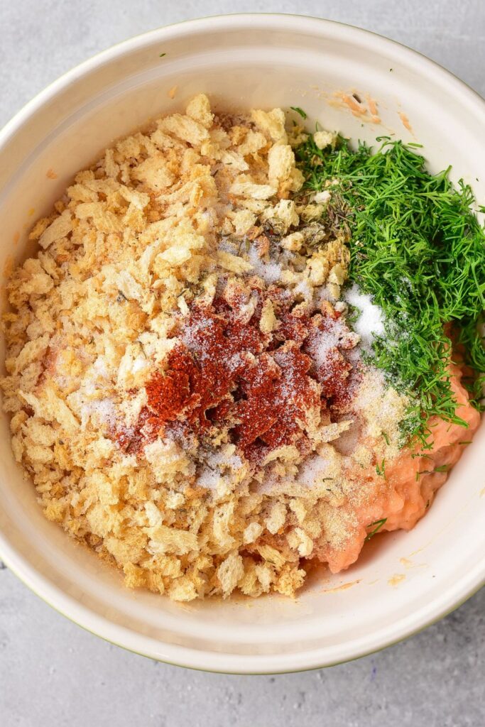 ingredients for salmon cakes in a bowl on counter 