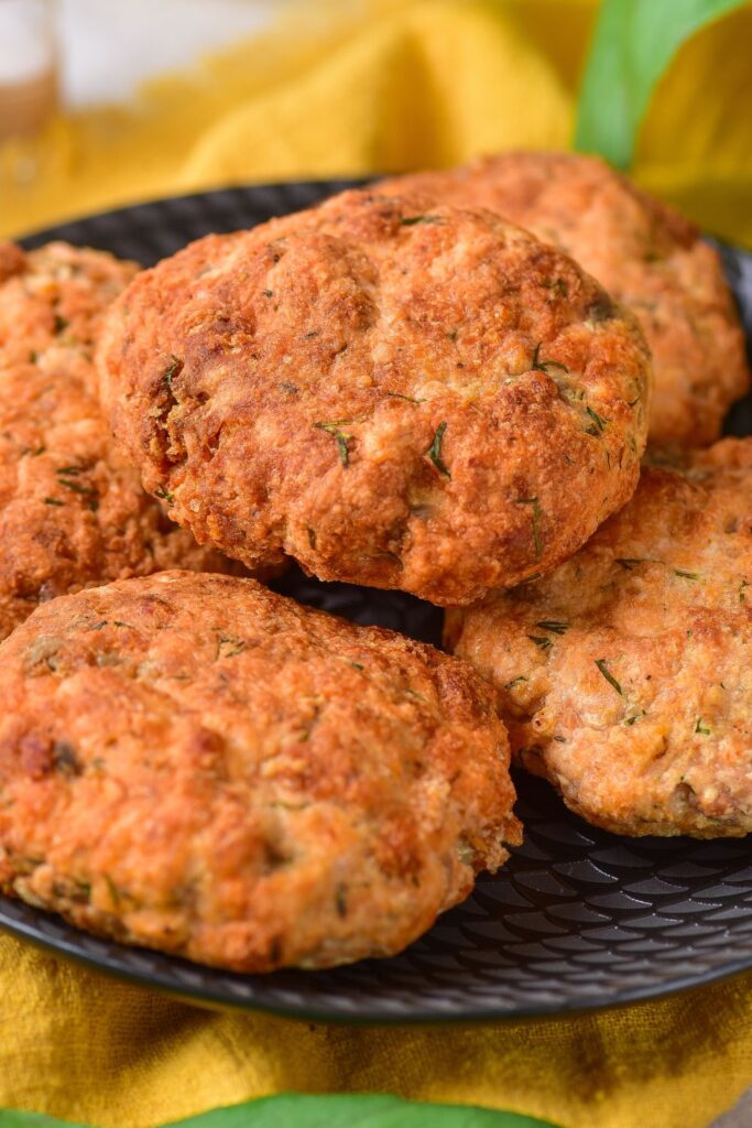 salmon patties on a black plate 