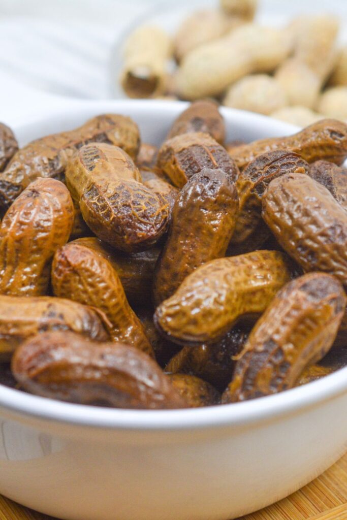 boiled peanuts in a bowl with fresh peanuts behind 