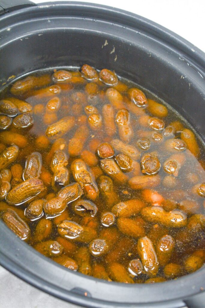 overhead view of boiled peanuts in a crockpot on counter 