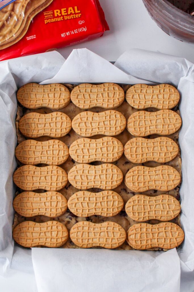 cookie dough and nutter butters in baking dish