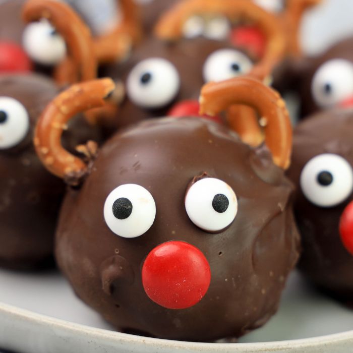 Oreo cookie balls that look like rudolph on white plate on table 