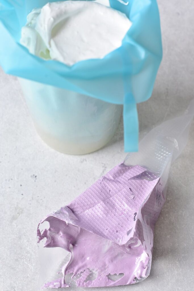 meringue in piping bag, with purple meringue in piping bag