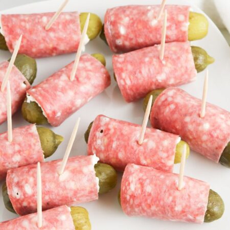 pickle roll ups on plate with toothpicks in it