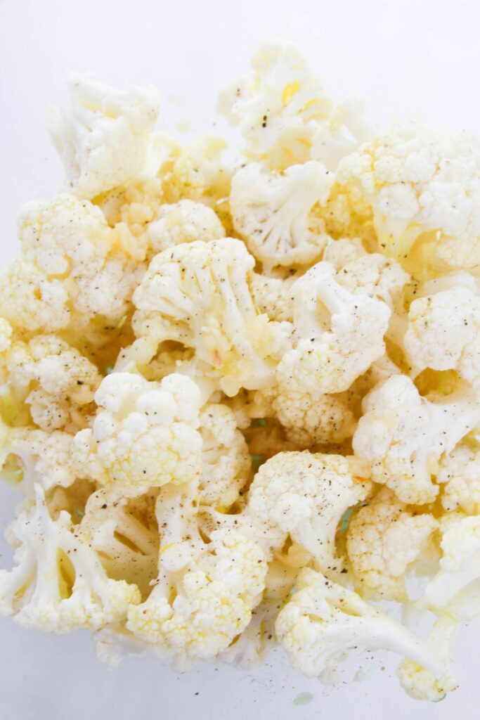 cauliflower florets seasoned in a bowl 