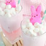 two glasses of pink punch and marshmallows with peep on top