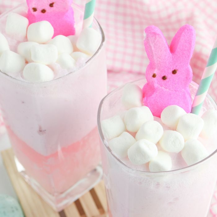 two glasses of pink punch and marshmallows with peep on top 