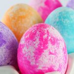 colored easter eggs in an egg holder