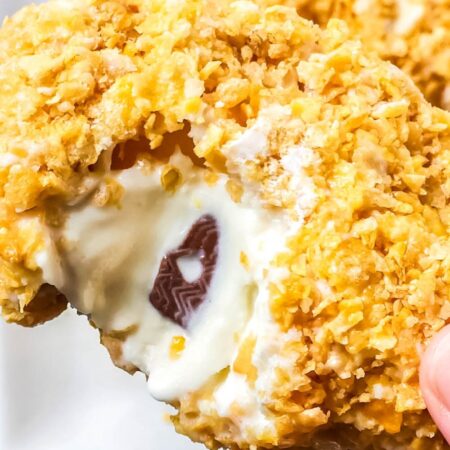 bitten taken out of fried chicken ice cream bar being held in hand