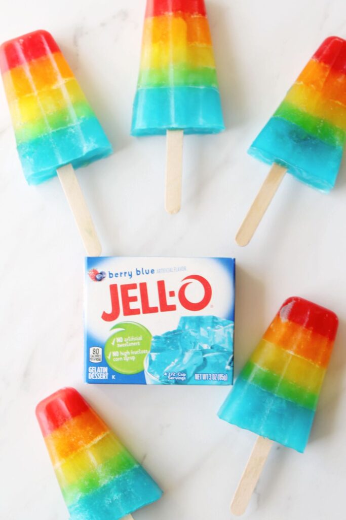 jello popsicles on a white table with box of jello