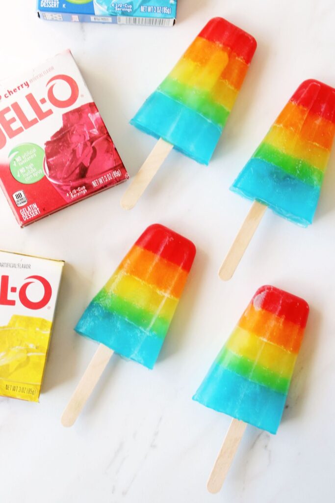 homemade ice pops on white table with boxes of jello on side