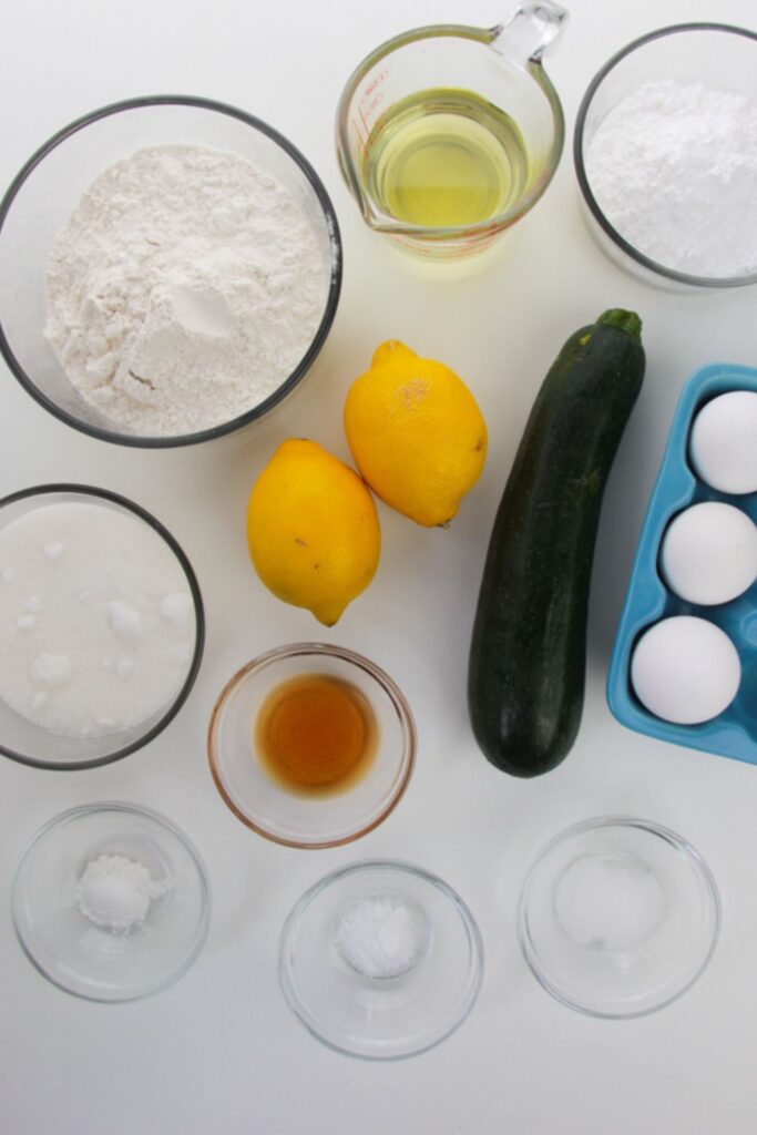 ingredients for lemon zucchini bread on a white counter 