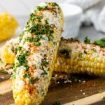 mexican elote corn on wooden cutting board