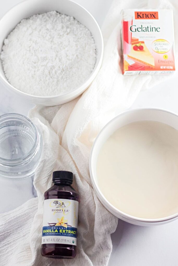 ingredients for stabilized whipped cream on table in white bowls