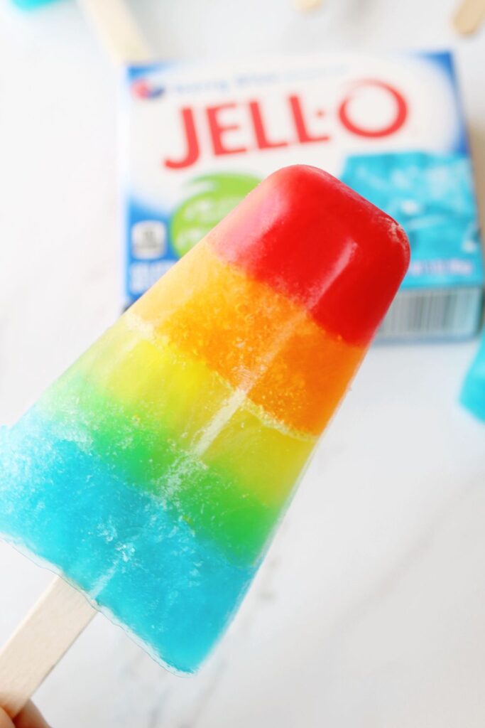 holding a layered jello pop in hand 