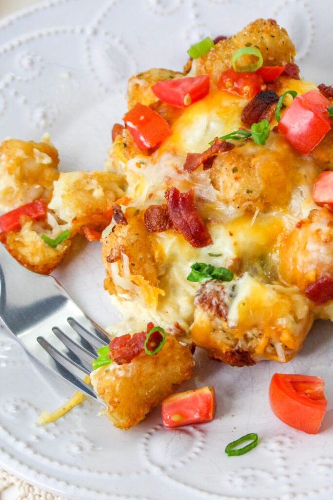 chicken tater tot casserole on plate with fork by it 