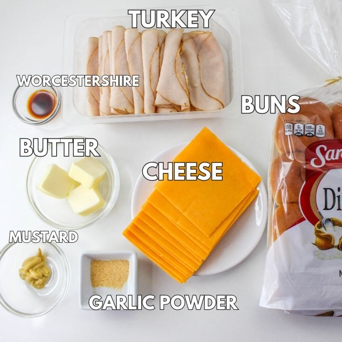 Ingredients to make turkey sliders on white table 