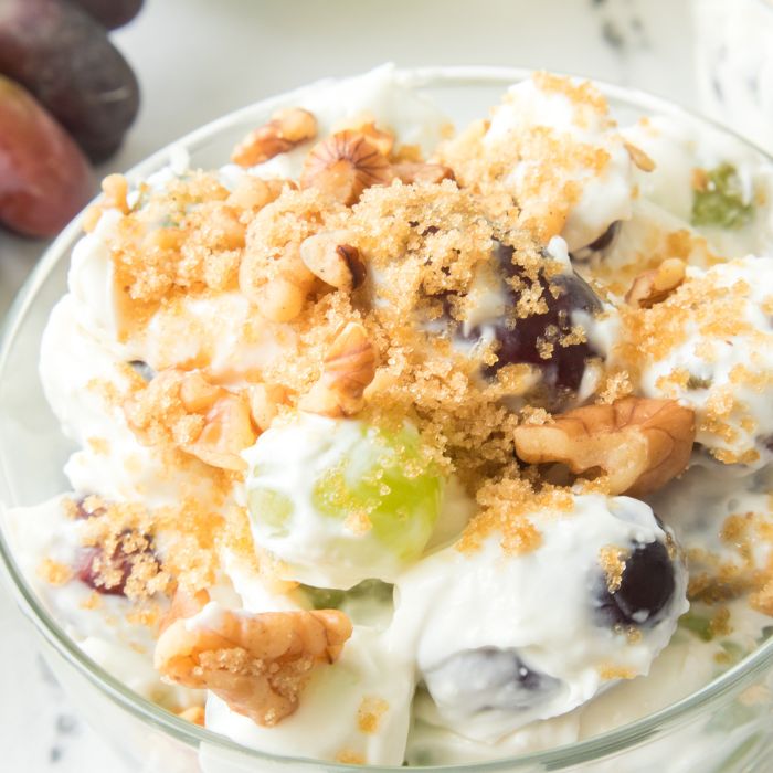 Grape Salad in a bowl topped with brown sugar and nuts