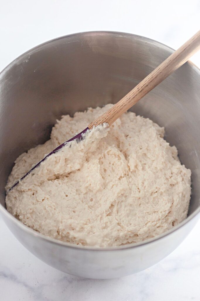 biscuit dough in a metal bowl getting mixed up