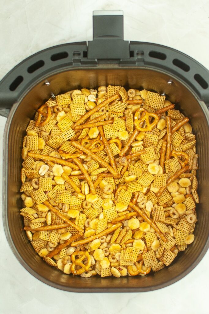 chex mix in an air fryer basket 