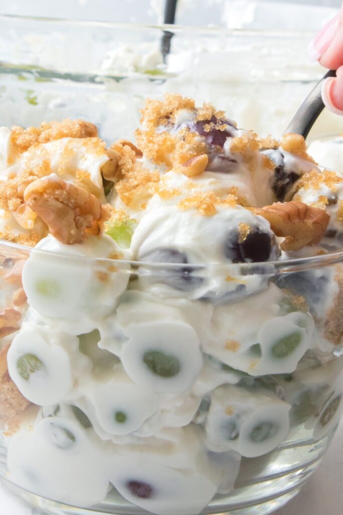 grape salad with walnuts in a glass bowl 