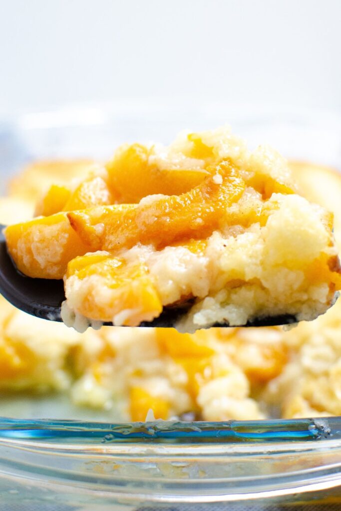 spatula with canned peached cobbler on top