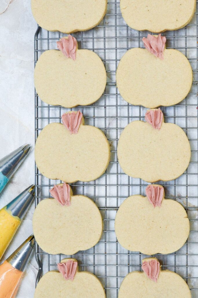 pumpkin sugar cookie with the stem piped on top 